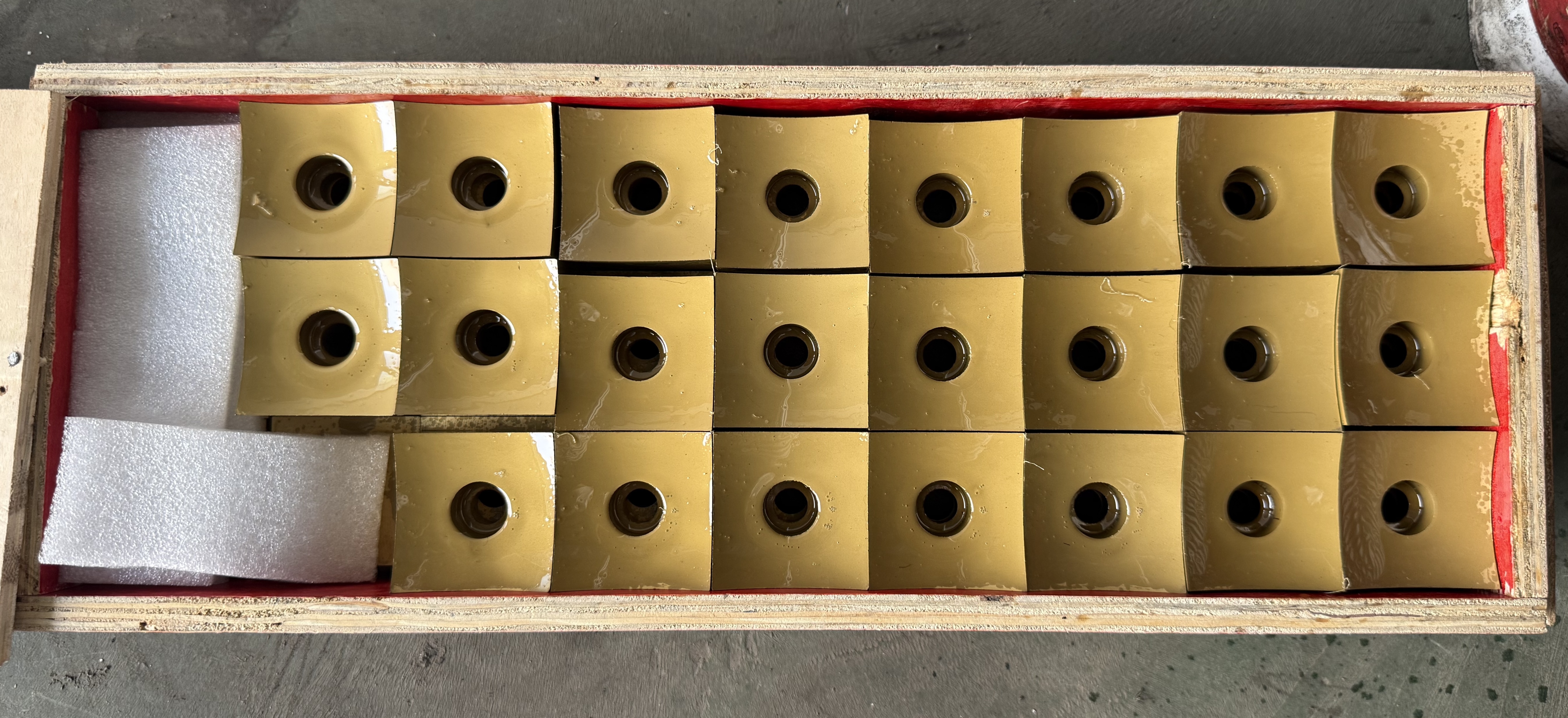 Overhead view of finished cutter inserts in their wooden crate