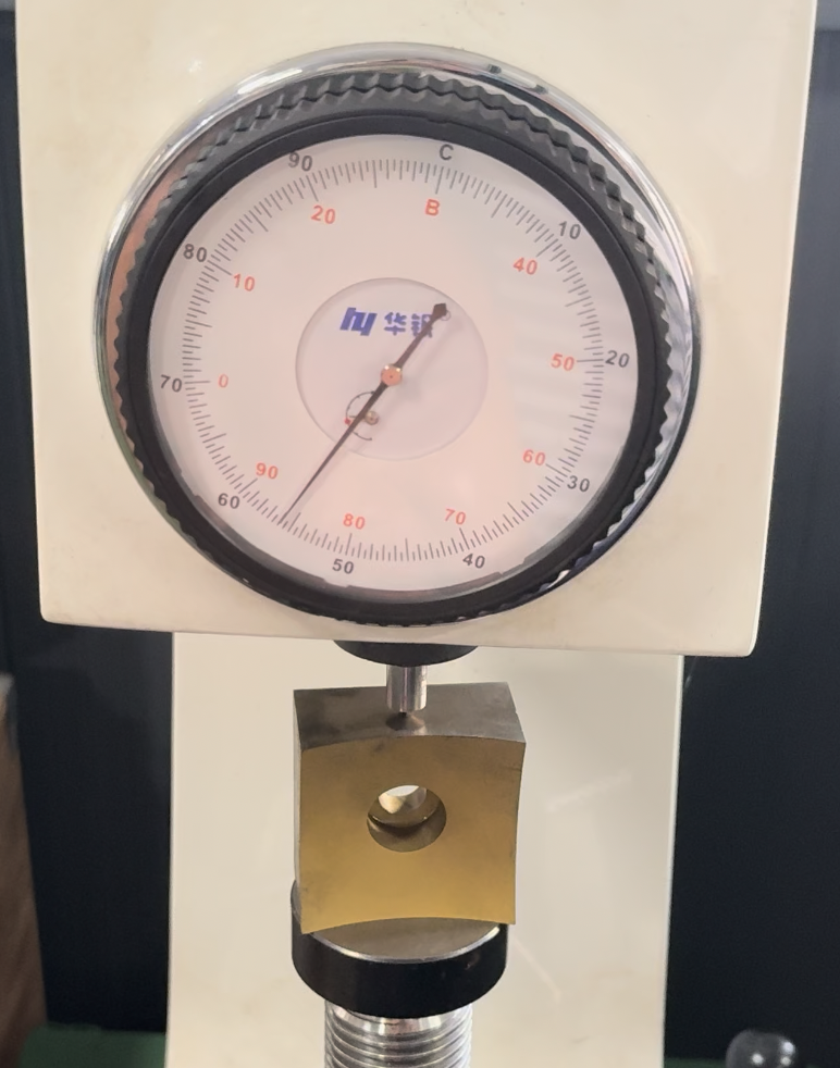 Full inspection photograph of the exposed D2 substrate beneath the hardness tester